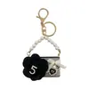 Influenciador mesmo estilo pequena bolsa Chanel camélia modelo chaveiro de carro moderna pequena bolsa floral não abre ornamento para pendurar