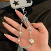 Funda de Teléfono Móvil con Cuentas de Concha y Lazo Lindo Cadena para Colgar Cadena de Cuentas Hecha a Mano DIY Cámara CCD Colgante Pequeño y Fresco