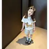Traje Infantil Novo Estampado de Verão 2026 Fino Estiloso Meninos e Meninas Super Fofo Manga Curta Shorts Conjunto de Duas Peças