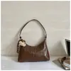 Bolso de axila coreano de nicho transfronterizo para mujer, nuevo bolso de moda tipo media luna 2026, bolso de hombro cruzado simple y versátil, moderno