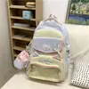 Mochila personalizada para estudante do ensino fundamental de nicho alto valor de aparência estilo acadêmico mochila de menina tecido Oxford boneca de desenho animado fofa bolsa de menina