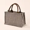 Nuevo bolso de mano de rayas transfronterizo, gran capacidad, bolso de moda trendy 2025, bolso de hombro de alto valor estético, bolsa para el almuerzo