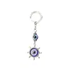 Llavero con diseño de ojos azules y brújula retro, colgante de copo de nieve y luna, con explosiones transfronterizas, accesorios para mochila.