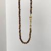 Colar de botões de ferradura de olho de tigre com retenção de cor Light Luxury High-end Sweet Cool Casual Sweater Clavicle Chain