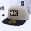 Gorra de Hip-Hop para Niños 2026 Primavera Nueva Gorra de Béisbol con Visera Moda Coreana Cara Sonriente Logo K Gorra de Baile Callejero Transfronterizo