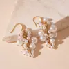 Pendientes de borla de flor de concha blanca transfronterizos europeos y americanos con perlas, pendientes de estilo de corte francés, pendientes ligeros y lujosos con un toque de alta gama