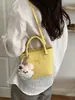 Bolso de mano de color liso con diseño único, bolso tipo cubo de moda, versión coreana ins dulce moderno para hombro y cruzado para mujer