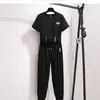 2025 Novo Verão Estilo Coreano Manga Curta Esportivo Casual Terno Feminino T-Shirt Curta Solta Calça Nove Pontos Conjunto de Duas Peças Tendência