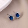 Brincos de zircão embutidos de cobre de venda quente transfronteiriça Europeu e Americano Royal Noble elegante esmeralda vermelha oval brincos de girassol