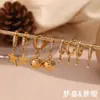 Pendientes creativos de personalidad con temperamento minoritario europeo y americano, acero inoxidable chapado en oro de 18 quilates, microincrustación de circonita, estrella de cinco puntas, cierre geométrico para la oreja