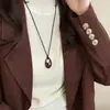 Collar con colgante ovalado de cordón de cuero estilo coreano, moda de nicho de alta gama, cadena simple para suéter, accesorio versátil personalizado para mujer