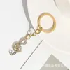 Cadena de Llaves y Colgante para Bolso de Mujer con Forma de Nota Musical Hueca y Completamente Incrustada con Pedrería, Estilo Europeo y Americano