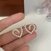 S925 nuevos pendientes de tuerca con forma de corazón y perlas de Dongdaemun, Corea del Sur, temperamento dulce, diseño Joker versátil