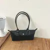 Bolso tote de estilo francés con nicho y asa larga, nuevo diseño de moda, bolso baguette de alta calidad, moderno y versátil, perfecto para llevar debajo del brazo