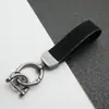 Colgante Llavero de Coche de Cuero Gamuzado Anillo de Resorte de Aleación de Zinc Cubierta de Llave Cadena de Llave con Logo de Coche Venta al por Mayor