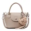 Bolso de Mano de Nueva Moda Primavera y Verano con Textura de Lichi, Femenino, Versátil y Estilo Occidental para Viajes Cruzado