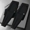 Calças masculinas para primavera e outono, calças casuais da moda com bolsos com zíper, calças esportivas jogger retas largas