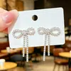 Artículo popular de comercio exterior: Pendientes largos de borla con pedrería y lazo de lujo ligero, pendientes largos brillantes de lujo ligero que hacen que el rostro parezca más pequeño