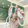 Colgante de concha curativa de moda, pulsera tejida, llavero de cadena de perlas, charm de bolso girly creativo, venta al por mayor