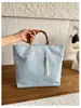 Nueva tendencia transfronteriza europea y americana 2026 tela moda gran capacidad bolso de mano de noche para mujer con asa de bambú