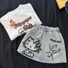 Traje de Verano para Niñas 2025 Nuevo Camiseta con Estampado de Dibujos Animados para Bebé Niña Falda Vaquera Estampada Linda Conjunto de Dos Piezas