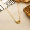 Moda europea y americana acero inoxidable lazo collar pendientes de botón traje mujeres 18k chapado en oro exquisito todo-partido temperamento no se desvanece