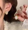 Brincos de borla estilo coreano Agulha de prata brincos de alta qualidade estilo francês imitação de pérola retro estilo quente olho de gato pedra brincos de nicho para mulheres