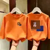 Camiseta de manga larga de algodón puro para niños talla mediana y grande, camiseta básica infantil de estilo coreano moderna y elegante para otoño 2026