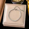 Pulsera de acero inoxidable de alta gama para nicho de venta caliente transfronteriza que no se desvanece, pulsera de trébol de cuerda roja perla para niña, joyería