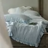 Conjunto de Quatro Peças em Tencel Lenzing Lavado à Areia Estilo Nórdico Classe A, Cor Sólida, Capa de Edredom Simples de Renda Amassada, Lençol de Cima, Lençol com Elástico em Estoque