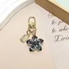 Nuevo Artículo Popular de Venta Cruzada Flor de Cinco Hojas Coreana Colgante de Pera Llavero Colgante de Bolsa Flor de Cerezo Pequeño Regalo