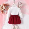 Conjunto de Roupa Infantil Novo Mais Vendido na Fronteira, Estilo Europeu e Americano, Conjunto de Duas Peças com Top de Manga Bufante em Forma de Coração com Laço e Saia Curta para Meninas