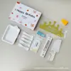 Set de accesorios para pastel de la fábrica de Ningjin, set de siete piezas en caja, velas de cumpleaños, sombrero de corona, cubiertos y platos de plástico desechables