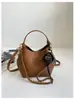 Bolso de mano de nicho estilo coreano transfronterizo para mujer, nuevo y moderno bolso cubo vintage con patrón de lichi, bolso de hombro y cruzado