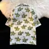 Camisa de solapa de manga corta de verano 2025, moderna, estilo Ins japonés, retro, casual, holgada, con estampado de flores hawaianas, camisa fina