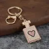 Llavero de botella de perfume con incrustaciones de diamantes, colgante de botella de perfume con pedrería en forma de corazón, accesorio de bolso de moda, regalo de llavero al por mayor