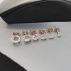 Aretes de tuerca de cuatro garras transfronterizos europeos y americanos Moda con incrustaciones de diamantes Simple Personalizado Pequeños Aretes de tuerca Hombres y Mujeres Mini Aretes de tuerca para cartílago al por mayor