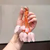 Llavero artístico de cuero con lirios del valle, cuerda tejida, cuentas de jade sintético y colgante floral, delicado accesorio de bolso femenino