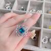 Anel de joia de amor azul-água Huguang Shui Ying banhado a ouro 18K cor Baodan em forma de anel de flor de zircônia