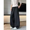 Calça de moletom retrô americana 2026 com cordão, solta e casual, design de retalhos, perna larga, estilo de perna curva, high-street, versátil e esportiva
