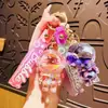 Astronauta Jelly Bean Botella Flotante Colgante para Mochila Astronauta de Dibujos Animados Llavero para Coche Regalo Pequeño para Pareja Venta al Mayoreo
