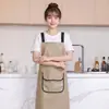 Delantal moderno impermeable y a prueba de aceite de PU lavable para cocina casera, delantal de cocina modelo nuevo, ropa de trabajo especializada para catering con texto impreso