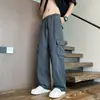 Pantalones cargo anchos de estilo retro para hombre, con bolsillos grandes, un diseño moderno y minimalista, colores lisos, un ajuste versátil y holgado, corte recto y cintura con cordón para uso casual.