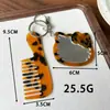 Peine espejo en forma de corazón, colgante de peine de acetato, accesorio de bolso simple y versátil, peine portátil con mango, llavero