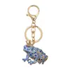Moderna moda europea y americana estilo retro unisex personalizado de moda accesorio colgante de llavero con forma de príncipe rana de dibujos animados