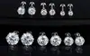 Moda europea y americana acero de titanio aguja fina seis garras redondo chapado en oro de 18K circonita aretes de botón aretes unisex joyería para piercing