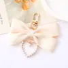 Nuevo Colgante Creativo de Cadena Colgante con Lazo de Perlas para Bolso, Funda de Teléfono, Llavero, Adorno, Exquisito Accesorio de Regalo Pequeño