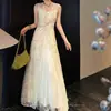 Vestido largo elegante negro Lanxi con encaje de lentejuelas, diseño de torsión en la cintura y parche de malla con abertura