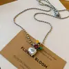 Novo colar de pérolas com pingente de coração de vidro com gota de óleo estilo europeu e americano, corrente de clavícula de design único, corrente de suéter da moda para mulheres