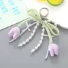 Nuevo Colgante Decorativo para Bolso Tulipán Dulce Cadena Colgante Versátil con Lazo de Perla para Funda de Teléfono Funda de Auriculares Accesorio